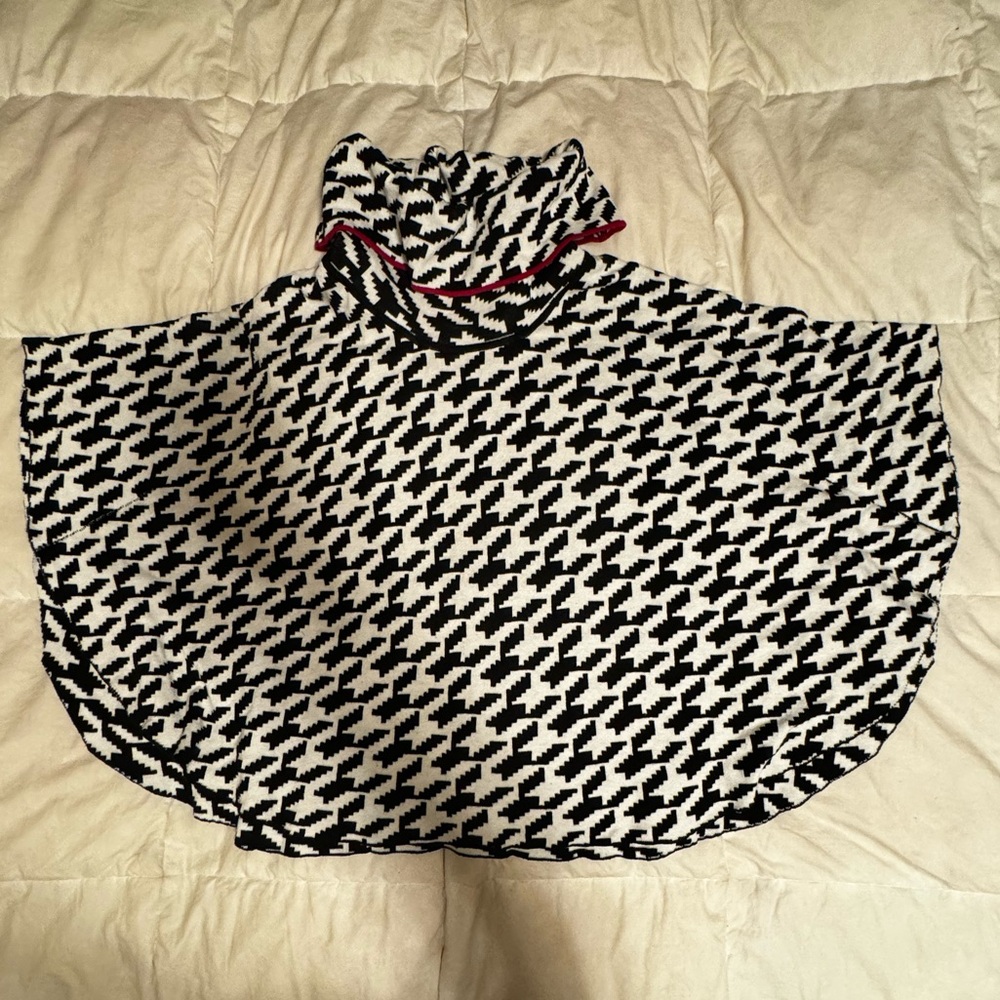Fever, Black and white poncho with red trim on the collar. Size Small/Medium